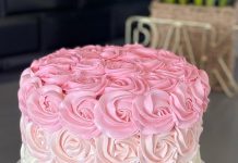 Pink and white cake with frosting patterned like roses