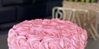 Pink and white cake with frosting patterned like roses