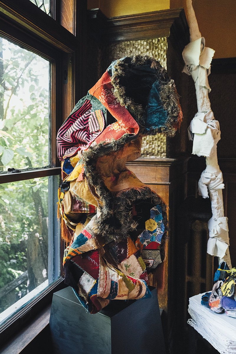 Dickey describes this sculpture as “antique fabrics applied to a plaster base sculpture along with a white painted ‘Voodoo’ totem.”