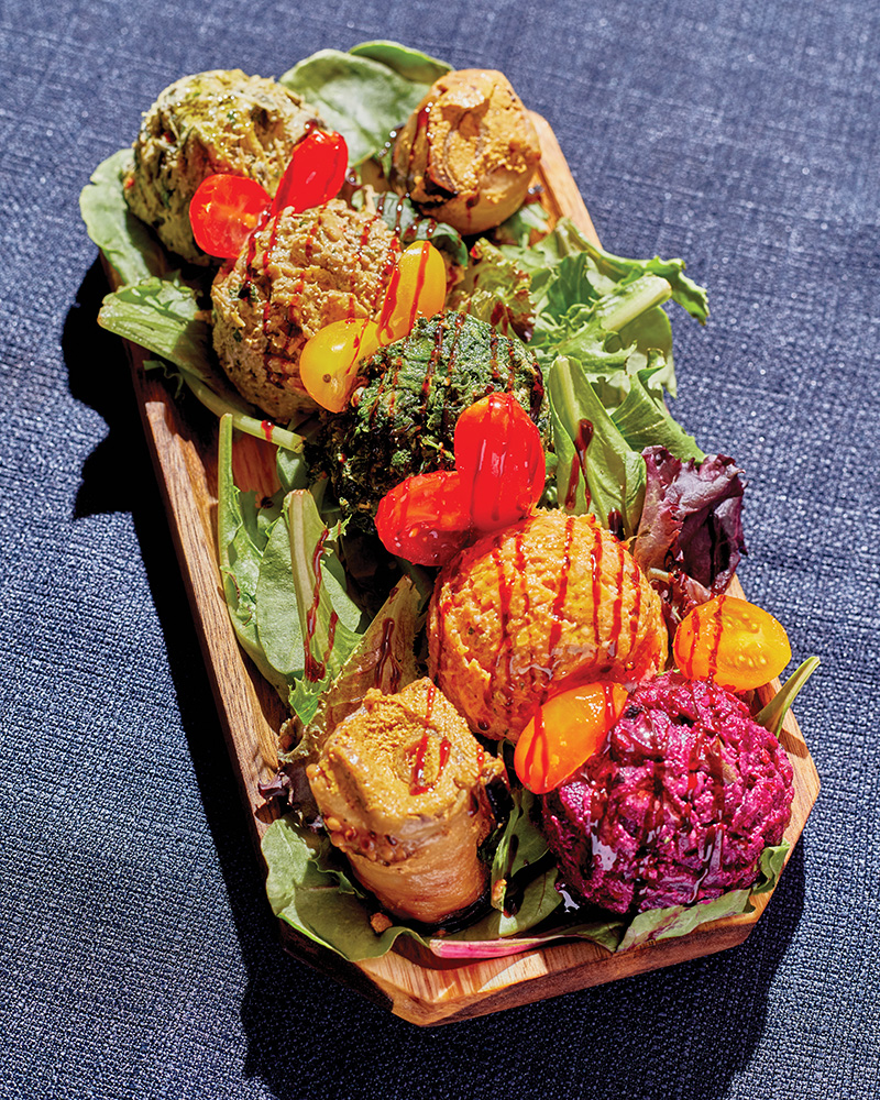 A Pkhalis Assortment: eggplant, spinach, pumpkin, beans, and leek with ground walnuts, herbs, Georgian spices, and pomegranate seeds.