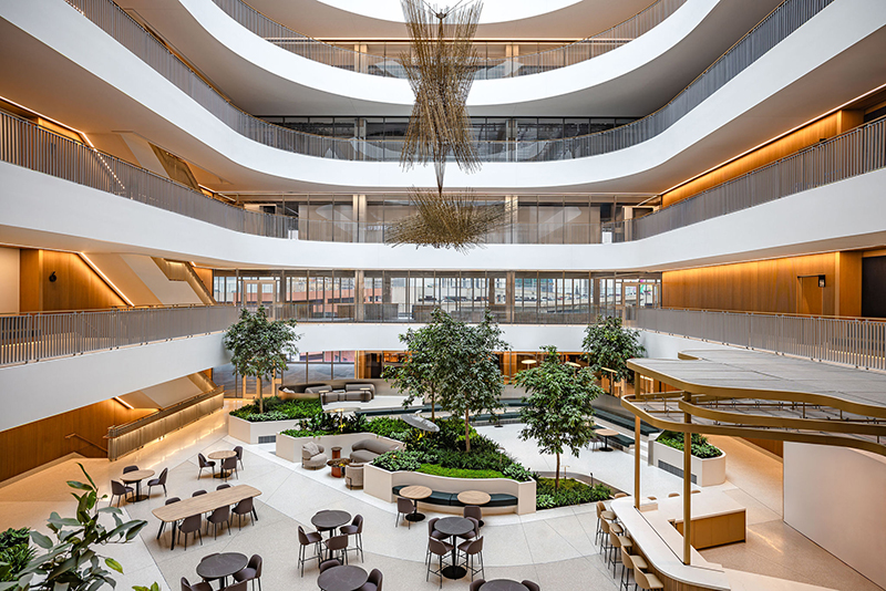 Located on the fifth floor of the office center at Hudson’s Detroit, the seven story glass-covered atrium allows for lots of natural light into the shared space.