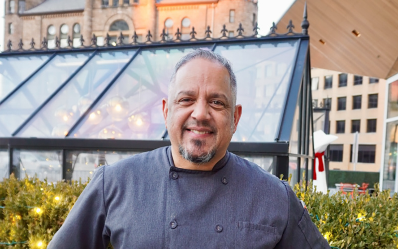 Aramis Torres, a former U.S. Marine and the current executive chef at Lumen, poses in Beacon Park outside the restaurant in downtown Detroit.