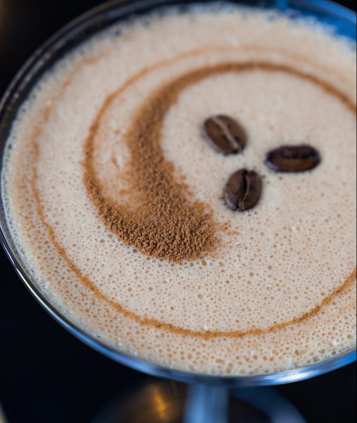Top of an espresso martini with three espresso beans as a garnish