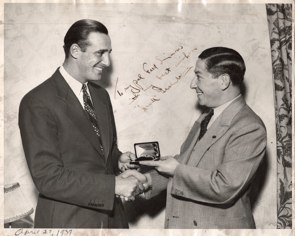 Hall of Fame Detroit Tiger Hank Greenberg purchasing a solid-gold Benrus watch from Simmons and Clark co-founder Fred Simmons.