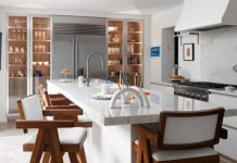 A Look Inside the Kitchen of Local Interior Designer Carrie Long Wide-plank white-oak flooring complements the Orley Shabahang runners. The teak stools have arms and include white boucle seats and backs.