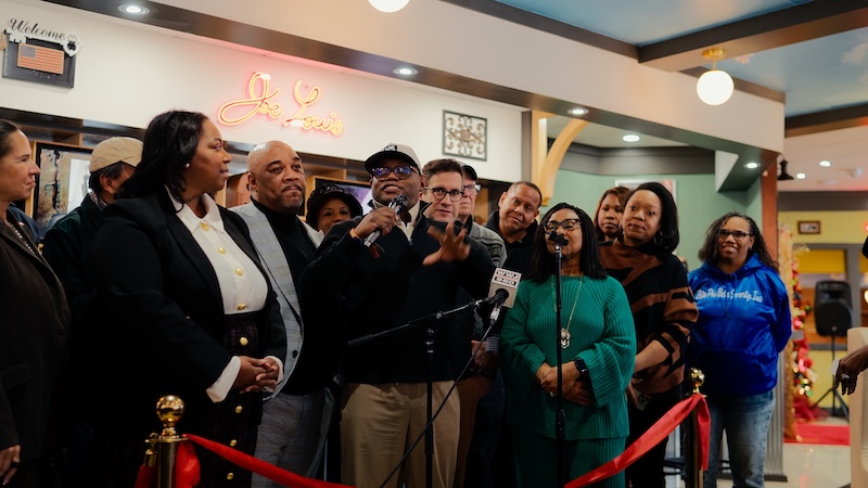 A crowd celebrates the ribbon cutting of Joe Louis Southern Kitchen in Southfield, one of our December 2025 Metro Detroit Dining News items