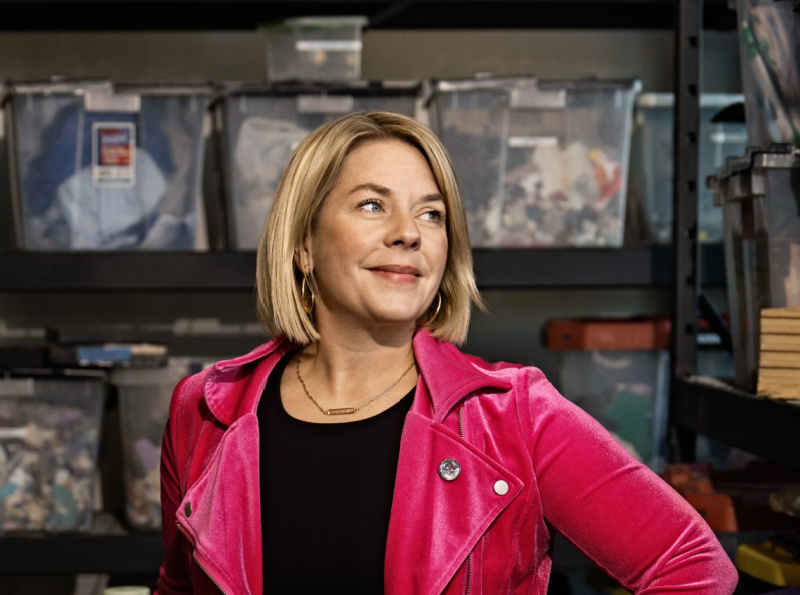 Rebel Nell co-founder and CEO Amy Peterson stands in front of bins containing pieces of Detroit history at Rebel Nell’s headquarters in Detroit.