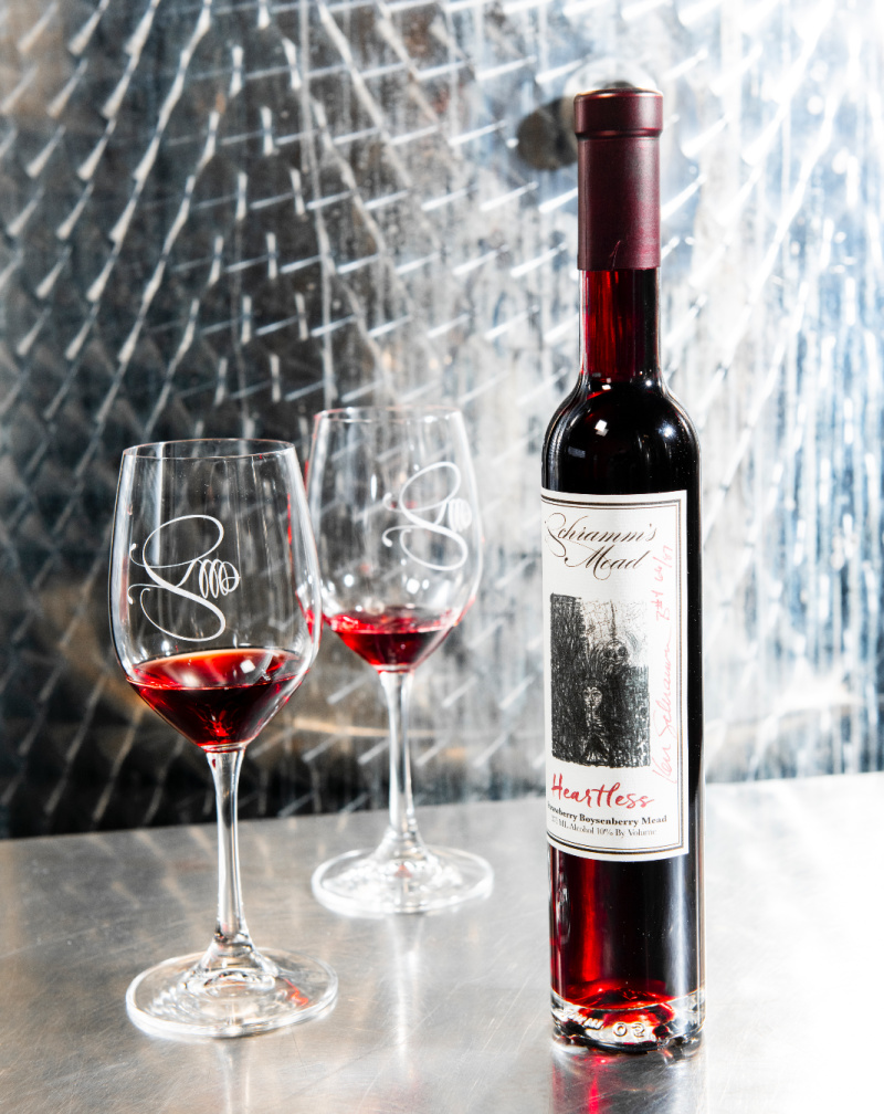 A bottle of Schramm's Mead's Heartless, a strawberry and boysenberry mead, with two glasses