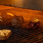 Steaks being chargrilled in a 1,600-degree broiler.