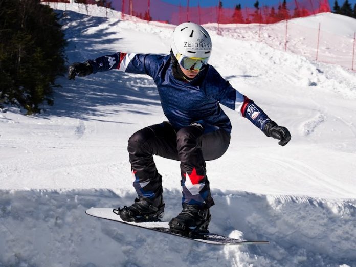 Jake Vedder snowboarding down a hill