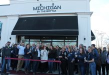 Owners, staff, and guests celebrating the opening of the new Michigan by the Bottle location in Lake Orion.