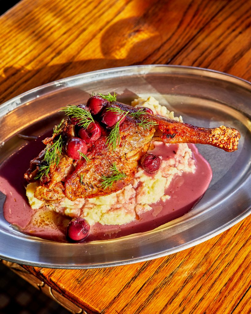 Confit duck leg with cherry glaze.