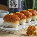 Made with masago, chives, sriracha, and chili oil, the spicy tuna crispy rice is topped with Serrano pepper for an added kick.