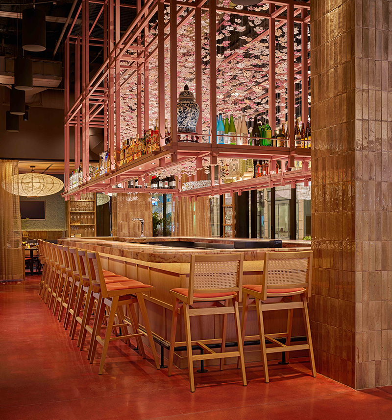 The island bar is a perfect spot for guests to have a drink and enjoy the cherry blossom decorations.