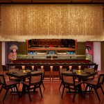 Capiz shells float above the sushi bar, as a mirror gives guests a view of the action behind the counter.