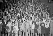 Child actor Jackie Cooper (front, center) photographed with dozens of children in the lobby of the Fisher Theater on May 7, 1932.