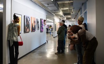 A woman posing with a piece at the CCS Student Exhibition