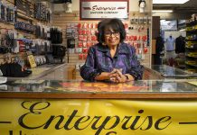 Lynne Burgess-Holmes posing at her counter.