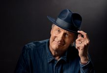 Jeff Daniels posing for a portrait, while wearing a fedora.